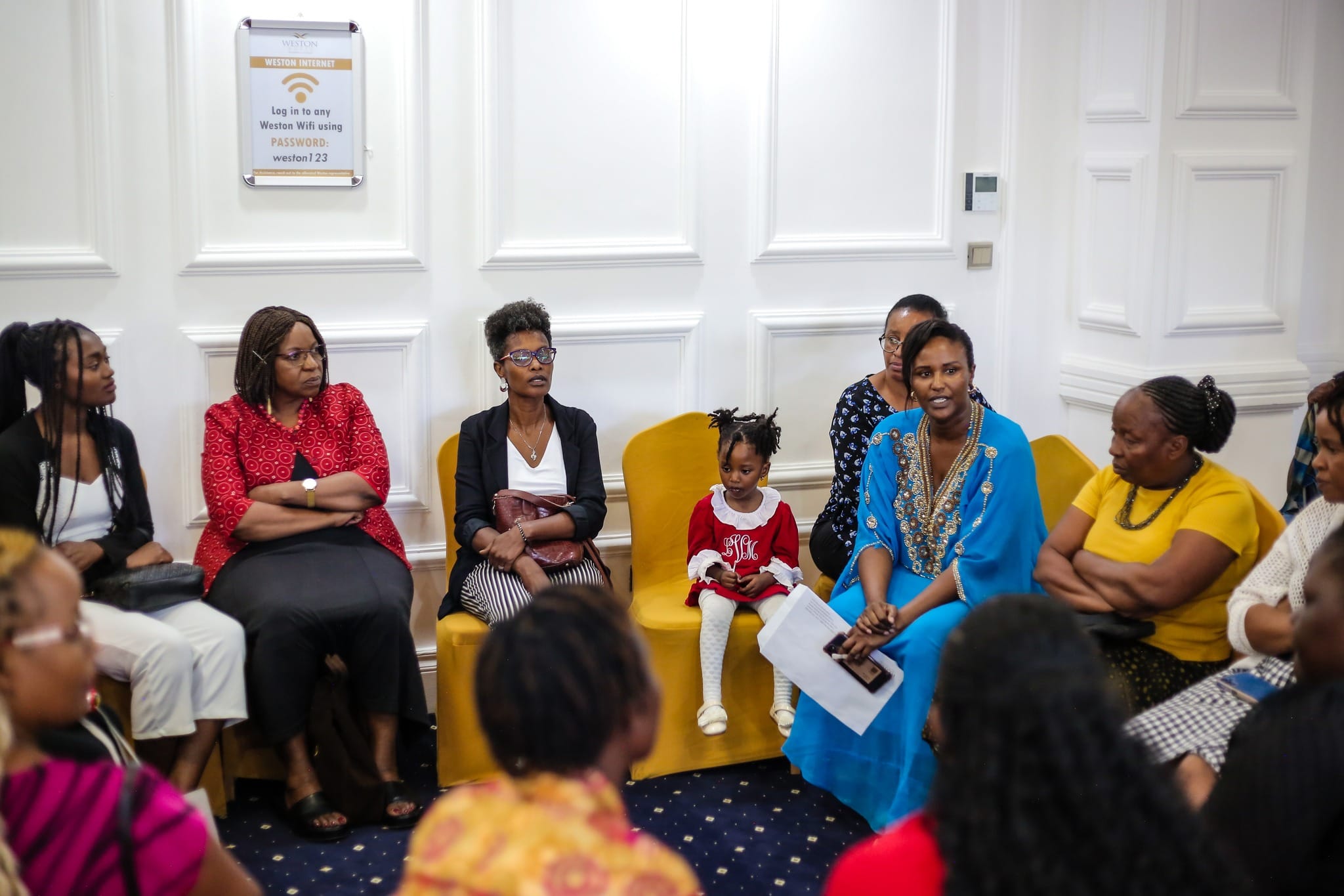 Group of TWC Women smiling and connecting during a church gathering, representing faith, sisterhood, and community.